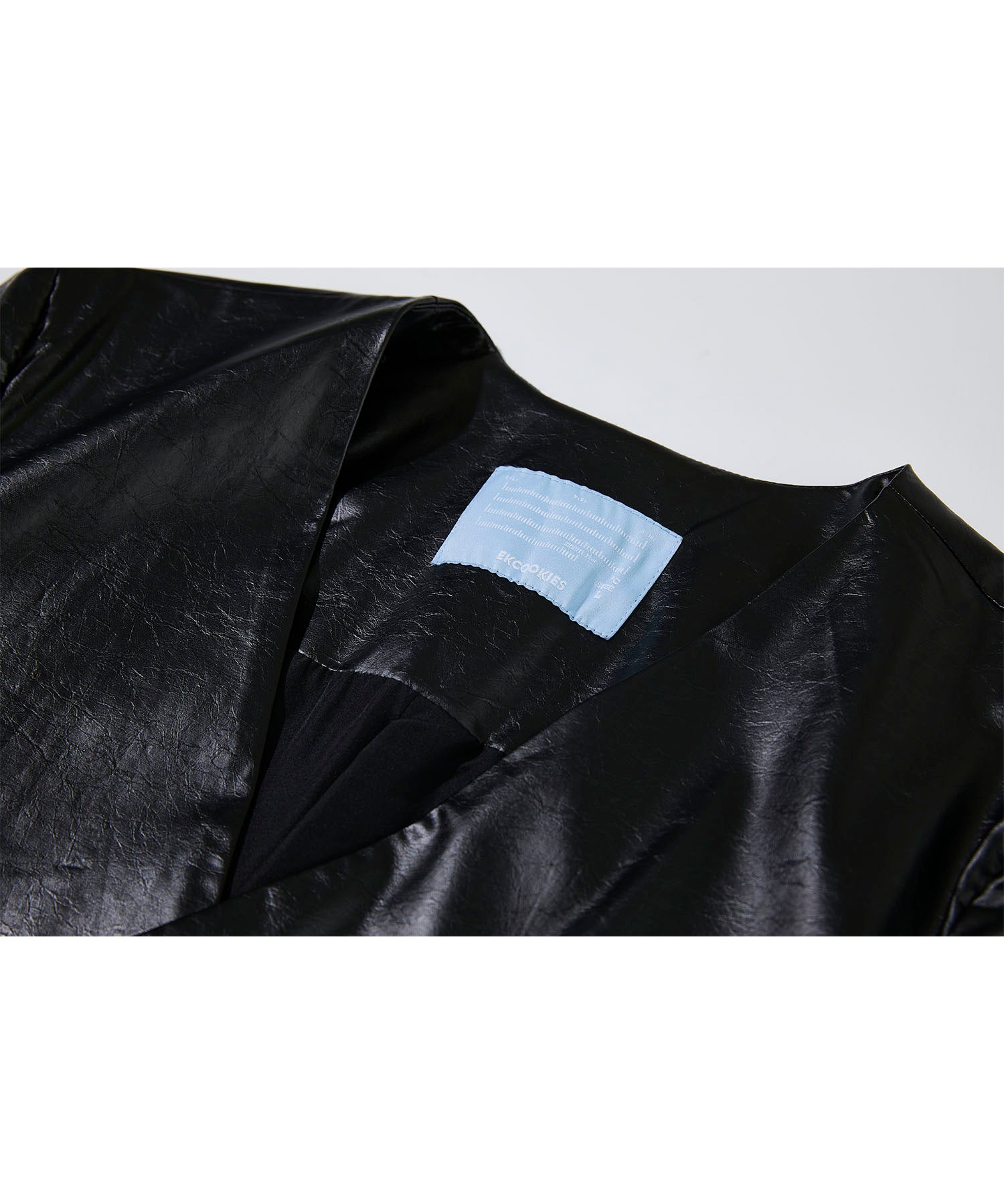Faux leather double-breasted collarless jacket
