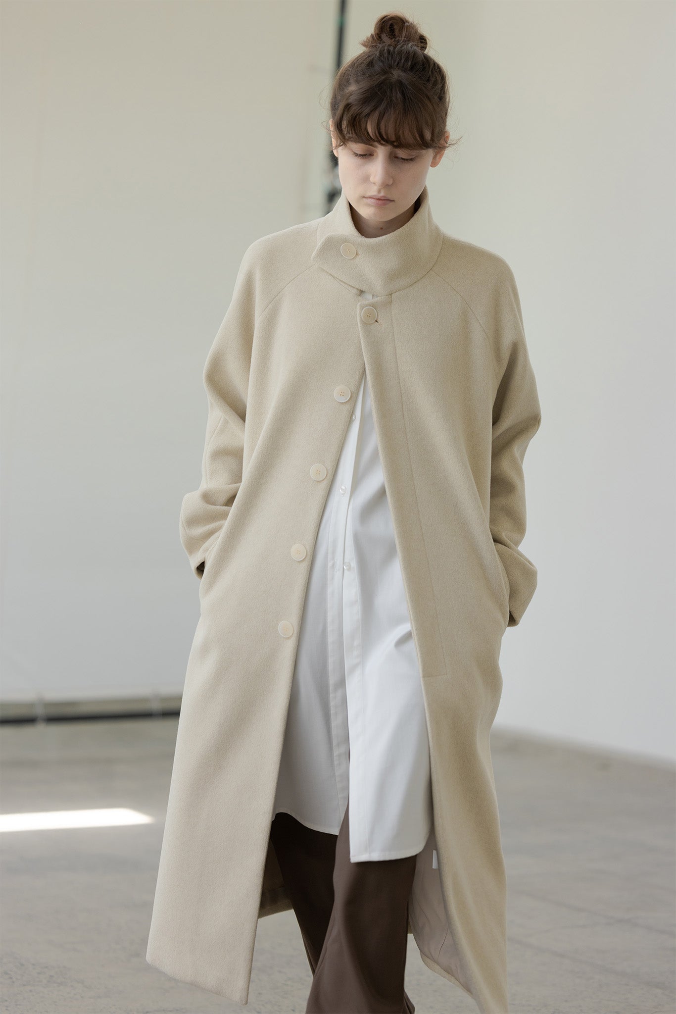 High neck stand collar over long coat 